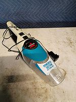 Top view of Bissell Bolt handheld vacuum showing branding and charger cord