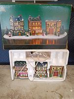 Box showing three Holiday Memories village buildings