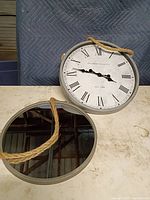 Front view showing clock and mirror with rope hangers
