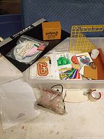 Overview of tote with polymer blanks, portfolio binder, quilting ruler, patches, vinyl swatches, transfer paper