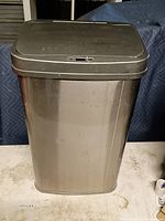 Front view of stainless steel motion sensor trash can