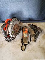 All three tools together: circular saw, angle grinder, drill