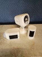 Three Ring devices grouped: spotlight, indoor cam, compact cam