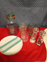 Group shot showing all items including large mason jar, plates, glasses, grinders