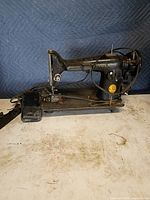 Full view of Singer sewing machine head on base