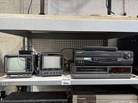 Front view showing two portable CRT TVs and two Sony components stacked