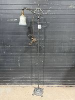 Full view of wrought iron bridge floor lamp showing height, base and cord