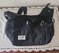 Full view of black Baggallini crossbody bag front side showing overall shape and strap