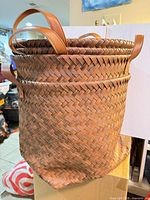 Side view of stacked woven baskets showing weave pattern and handles