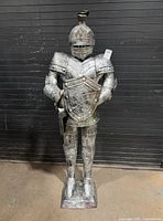 Front view of full-size knight statue on base