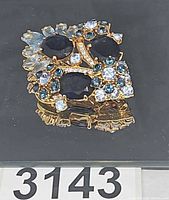 front view showing stone arrangement and gold-tone setting