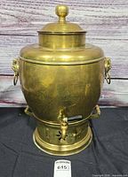 Front view of brass samovar showing spigot, lid, and overall form