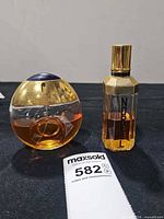 Boucheron and Norell bottles side by side showing overall condition and fill levels