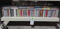Full view of bottom shelf with entire row of CDs