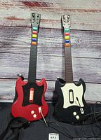 Front view of both wired Gibson SG controllers, red and black