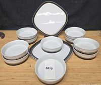 Full view of all 3 plates and 10 bowls arranged on table