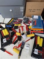 overview of lot showing paint rollers, trays, foam brushes, corner painter, brushes