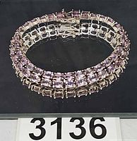 Full view of bracelet in closed loop showing double row of lavender stones