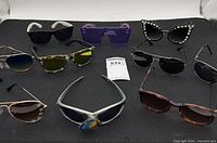 Group shot of all ten sunglasses on black background