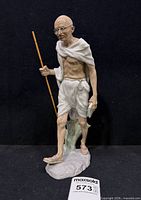 Full view of Lladro Mahatma Gandhi figurine on black backdrop