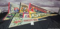 Group shot of nine vintage felt pennants overlapping on table