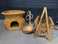 Cat bed, magazine rack and handled basket grouped together
