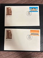 Both First Day Covers side by side showing entire fronts with stamps and cachets