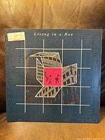 Front sleeve with grid artwork and price sticker visible