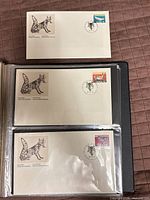All three First Day Covers in protective album page and one loose for clarity