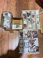 Overview of multiple cardboard boxes filled with loose hockey trading cards