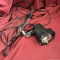 Full view of spotlight with clamp and cord