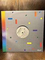 Front of sleeve showing grid design and center die-cut revealing label