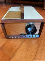 Front view showing lens, gold front panel and Realist 620 badge
