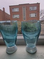 Both aqua-teal etched drinking glasses front view