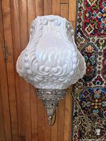 Full view of milk glass pendant light showing shade form and brass fixture