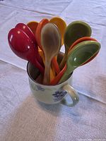 Spoons placed inside Johann Haviland mug, front view