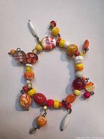 Full view of charm bracelet showing variety of beads and overall form