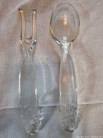 Glass salad fork and spoon full view