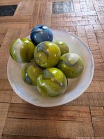 Top view of opaline bowl with seven marbled glass spheres