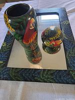 Vase, lidded box and framed mirror grouped together