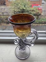 Full view of goblet showing amber bowl, clear stem, applied handle