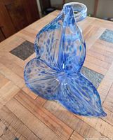 Front view showing blue speckled petal form and clear glass edge