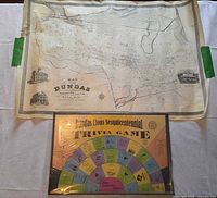 Full view of rolled reproduction map and sealed trivia game