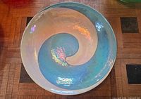 Top view of iridescent blue ceramic swirl bowl interior