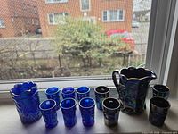 Group view showing both pitchers and all ten shot glasses