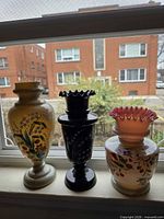 Front view of all three hand-painted vases on windowsill