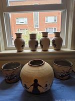 Full lot showing four vases, two planters with saucers, one large round planter