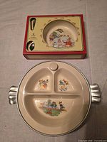 Bowl boxed with spoon and divided warming plate displayed