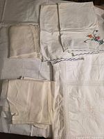 Folded stacks showing pillowcases, napkins and bedspread