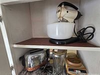 Upper shelf showing GE stand mixer and bowl